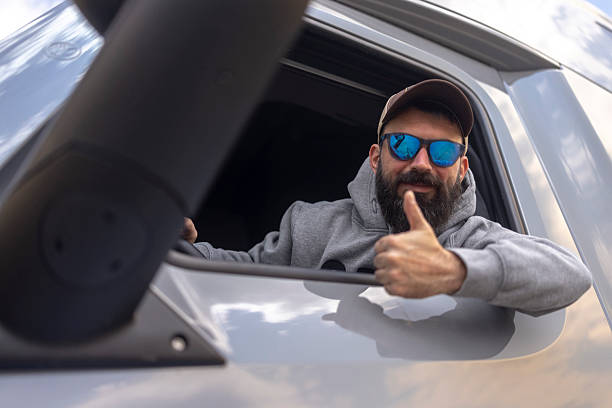Male truck driver thumbs up