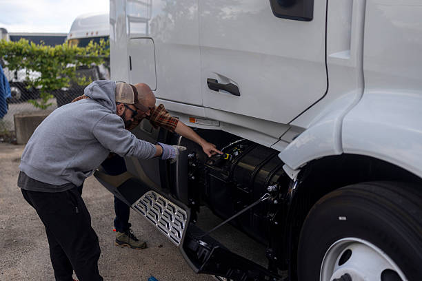 istock Truck Drivers Inspecting Engine in Outdoor Setting 2234997332