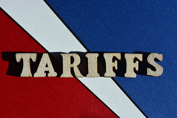 Tariffs, word in wooden alphabet letters isolated on red, white and blue background