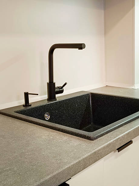 istock Black kitchen sink with faucet close-up. Vertical photo. 2235003253