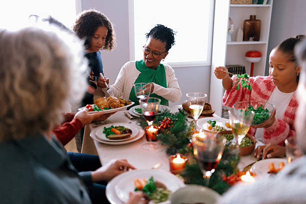istock Family members passing dishes at holiday dinner table 2235004271