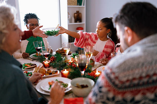 istock Family members passing dishes at holiday dinner table 2235004299