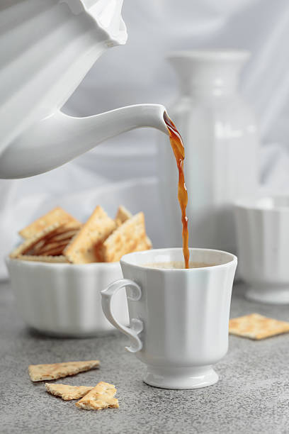 istock Black coffee in white porcelain cup and crunchy square crackers. 2235007666