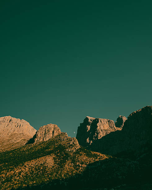 istock Daytime Moon over Majestic Mountains 2235007819