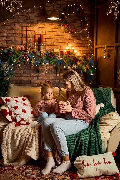 istock A mother and daughter opening a magical gift 2235008439