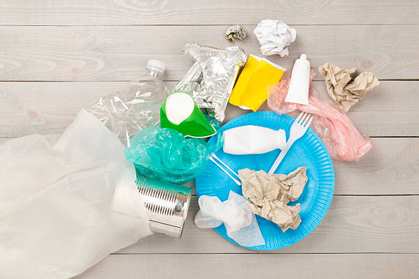 istock Bag with unsorted waste on wooden background, top view 2235011367
