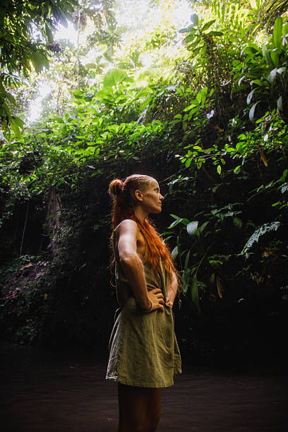 istock Woman exploring lush jungle environment surrounded by vibrant green vegetation 2235012031
