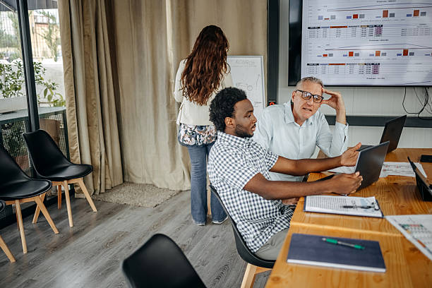 istock Small group of people having a business meeting using laptops 2235012622
