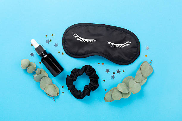 istock Sleeping mask with accessories on color background, top view. Sleeping routine concept 2235012724