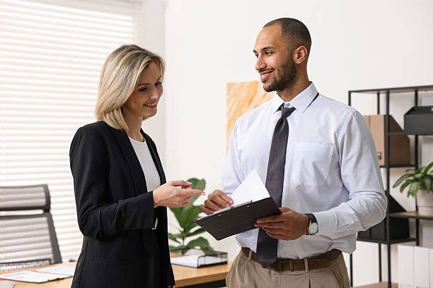 istock Coworkers with clipboard working together in office 2235013852