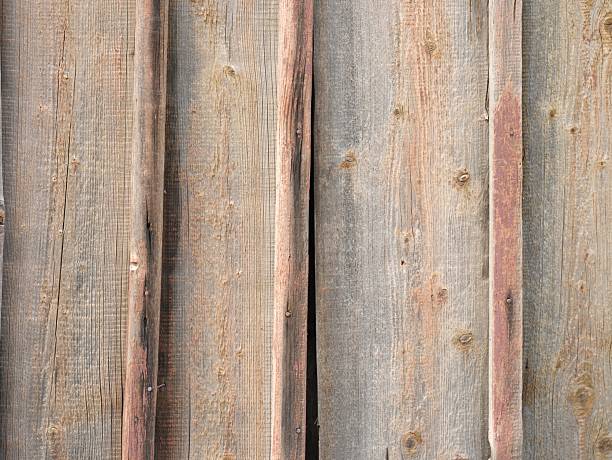 Time and weather leave their mark on this rustic wooden wall, each plank telling a story of years gone by.
