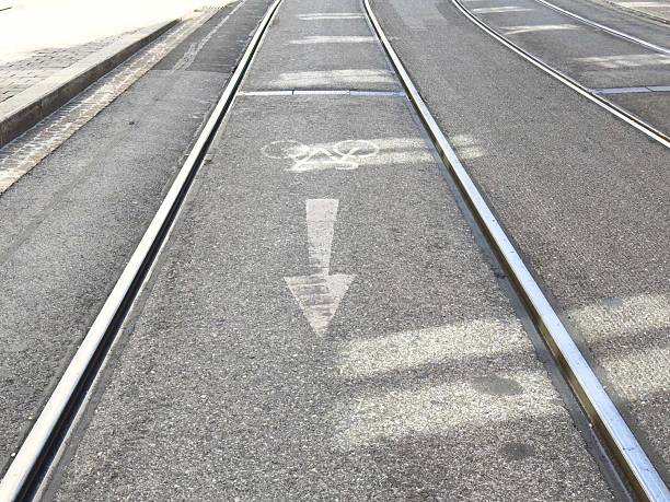istock Bicycle lane on tram track intersection marked with arrow symbol 2235017383