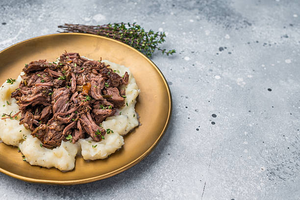 istock Homemade French Beef Bourguignon Stew on a plate with mashed potatoes. grey background. top view 2235020899