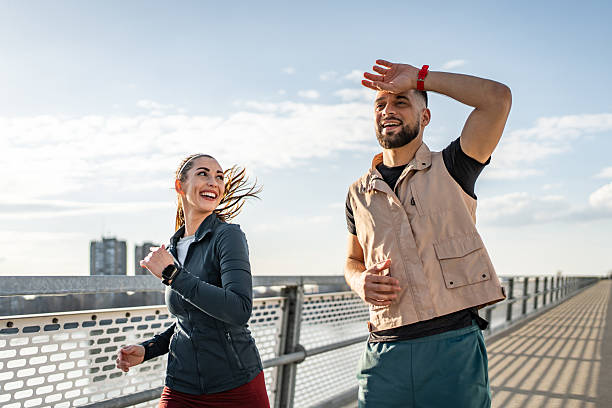 istock Happy couple running outdoors on a sunny day 2235020968