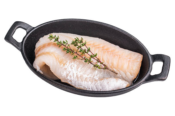 istock Pristine raw cod fillet, waiting to be marinated and cooked to perfection for a delightful dining experience. isolated on white background. top view 2235023530