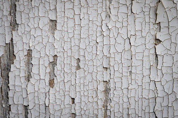 istock Old painted wooden board with peeling white paint texture 2235024325