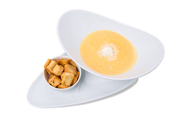 Pumpkin cream soup with cheese and roasted rusks. Isolated on a white background.