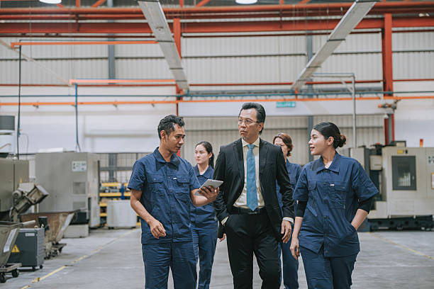 istock Asian Management and production team walking through modern manufacturing facility 2235025949
