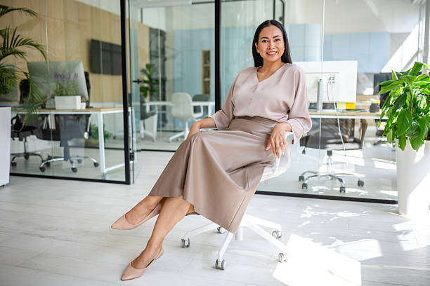 istock Confident Asian businesswoman enjoying her workspace in a modern office environment 2235026876