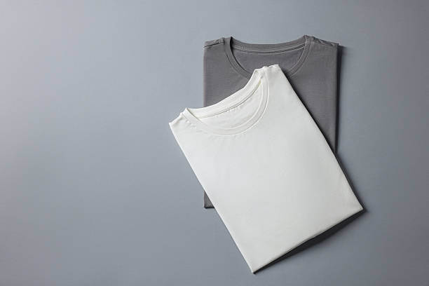 istock Different blank t-shirts on grey background, top view. Mockup for design 2235031831