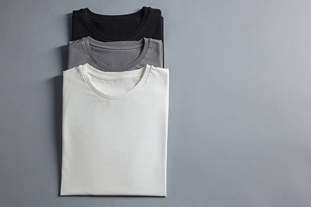 istock Different blank t-shirts on grey background, top view. Mockup for design 2235031859