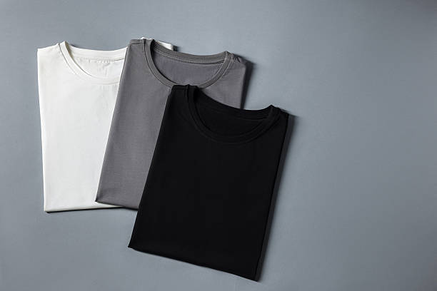 istock Different blank t-shirts on grey background, top view. Mockup for design 2235031899