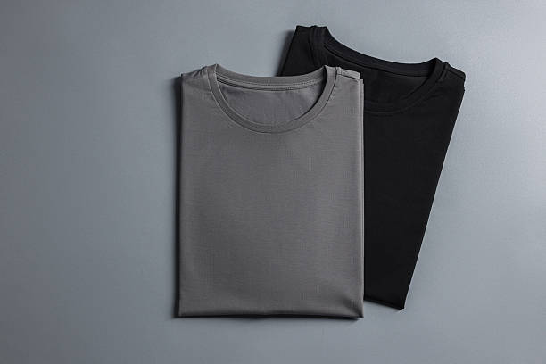 istock Different blank t-shirts on grey background, top view. Mockup for design 2235031950