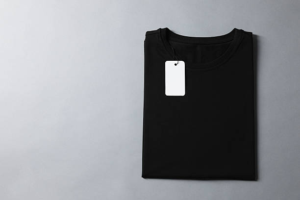istock Blank black t-shirt on grey background, top view. Mockup for design 2235031974
