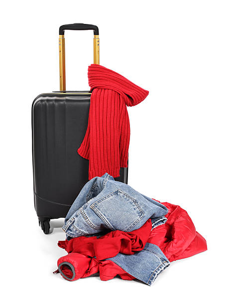 istock Suitcase and messy pile of clothes isolated on white 2235034149