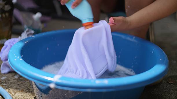 istock Asian mom doing household laundry cleaning student uniform at home. 2235034297
