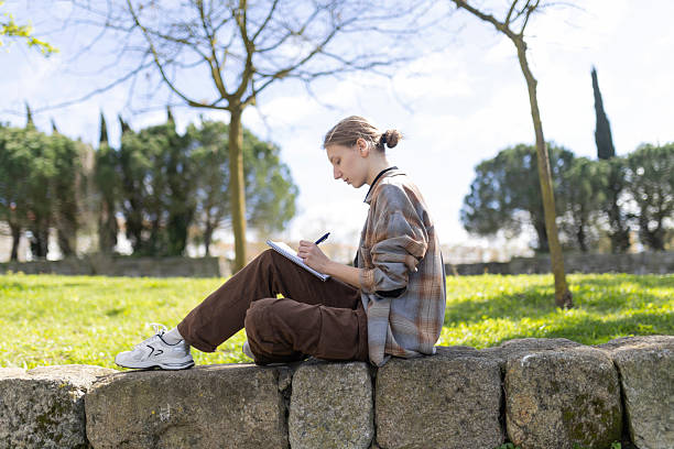 istock Young artist drawing outdoors in a park: finding inspiration in nature 2235034393
