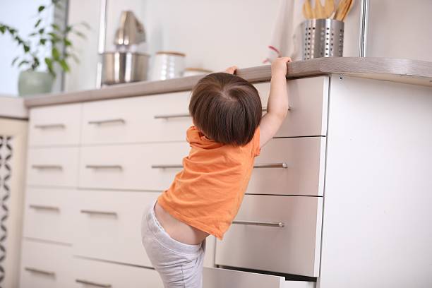 istock Little boy playing with kitchen appliances indoors, back view. Dangerous situation 2235034657