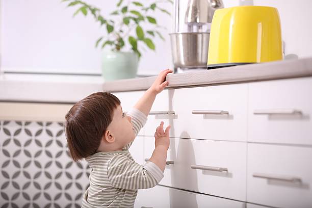 istock Little boy playing with toaster in kitchen. Dangerous situation 2235034916