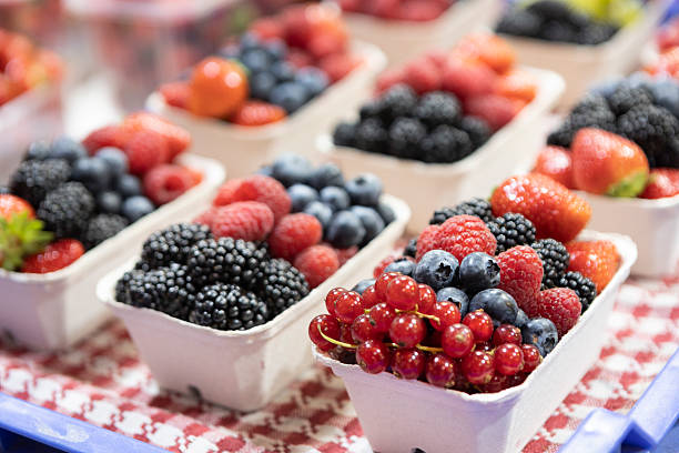 Beautiful homegrown various berry fruits in plastic crates.