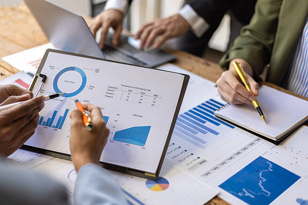 istock Business people analyzing charts and graphs during a meeting. Business team analyzing financial charts and graphs, discussing strategies. 2235036572