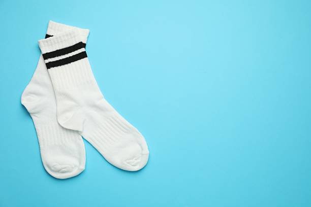 istock Pair of soft socks on light blue background, top view. Space for text 2235037819