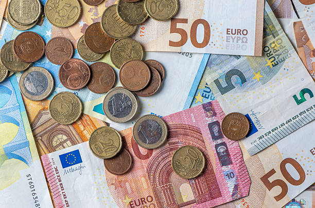 istock Euro bills and coins background macro view 2235039141