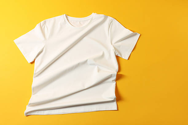 istock One t-shirt on yellow background, top view 2235039146