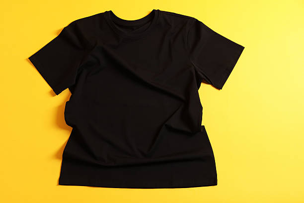 istock One t-shirt on yellow background, top view 2235039441