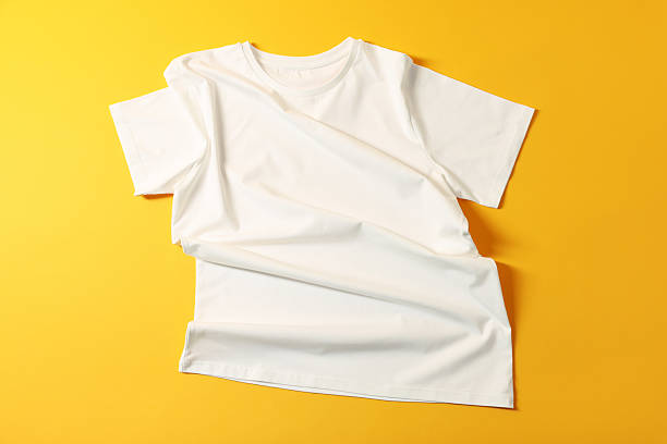 istock One t-shirt on yellow background, top view 2235039609