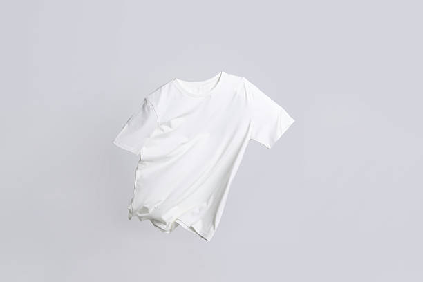 istock One stylish t-shirt in air on white background 2235039770