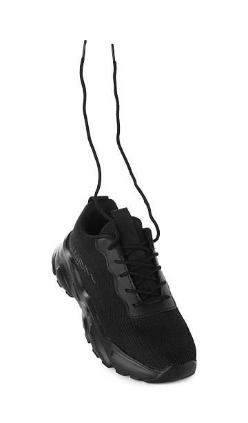 One black sneaker in air isolated on white