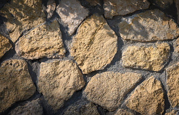 istock Close-up of rustic natural stone wall texture. Perfect for architectural design, decorative background, construction and creative projects. 2235041831