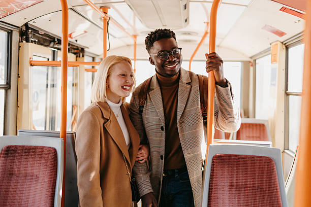 istock Young couple smiling and holding hands on a tram 2235047630