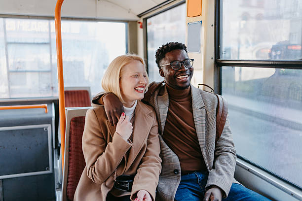 istock Young multi-ethnic couple laughing and embracing on the bus 2235047697