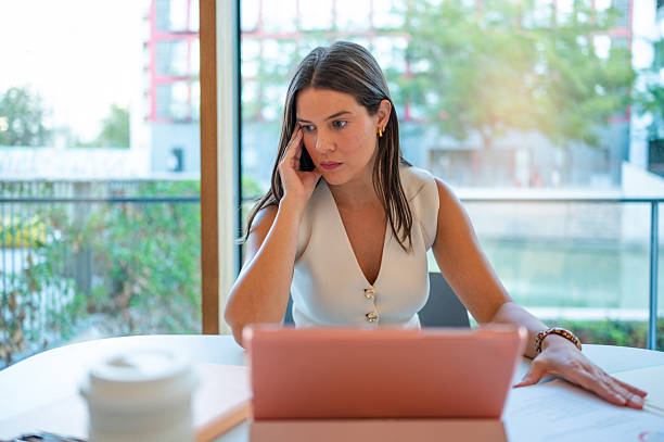 istock Businesswoman working with laptop looking concerned and stressed 2235048658