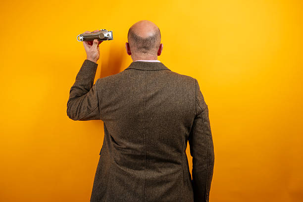Studio portrait of a middle eastern middle-aged bearded businessman posing against a dark background