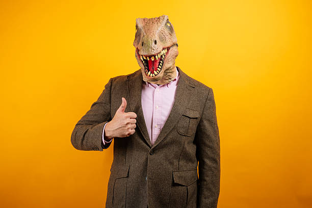 istock Dinosaur head businessman celebrating victory pose 2235048765