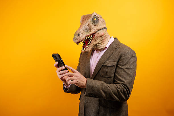 istock Dinosaur masked man typing on phone 2235048775