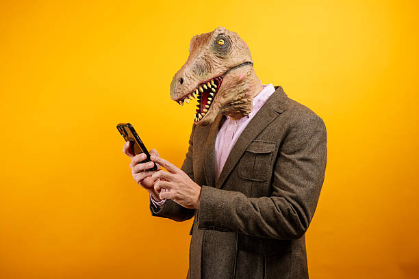 istock Dinosaur masked man typing on phone 2235048779